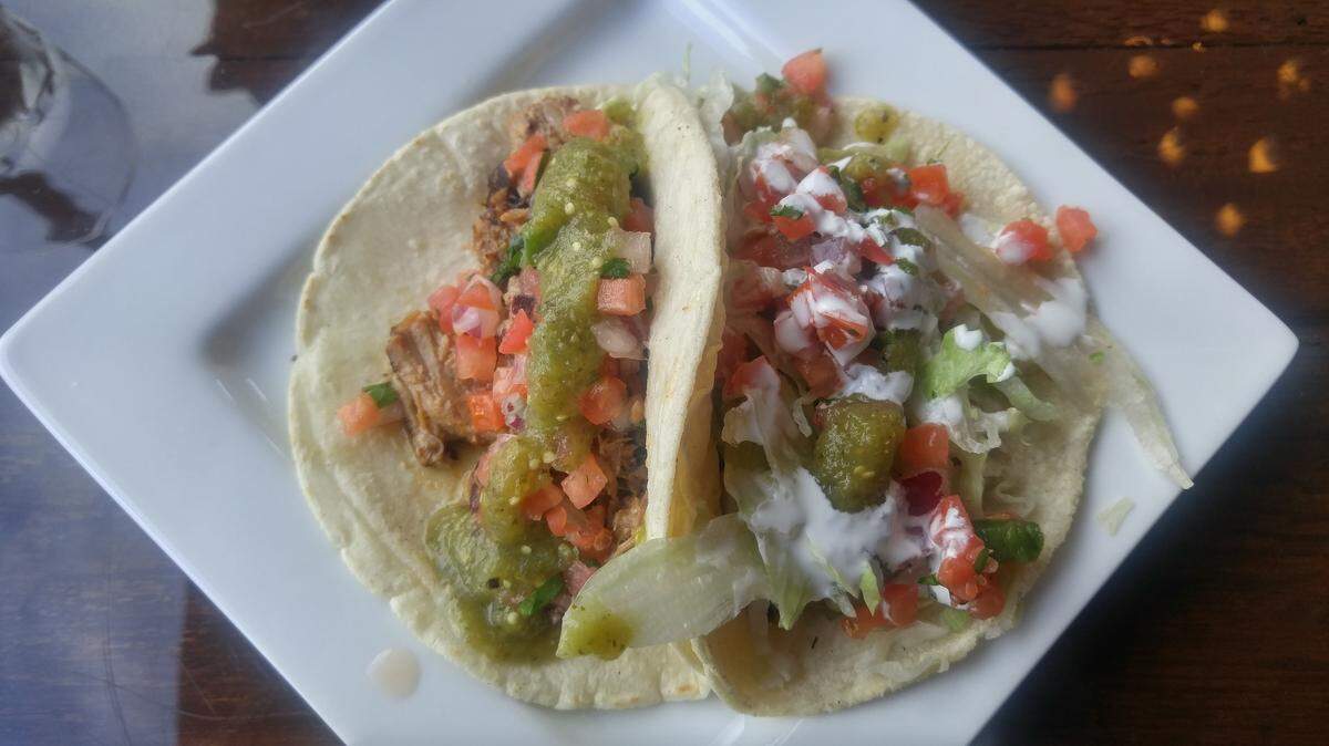 A carnitas and tequila-lime chicken taco from Red Star Taco Bar Tacoma.