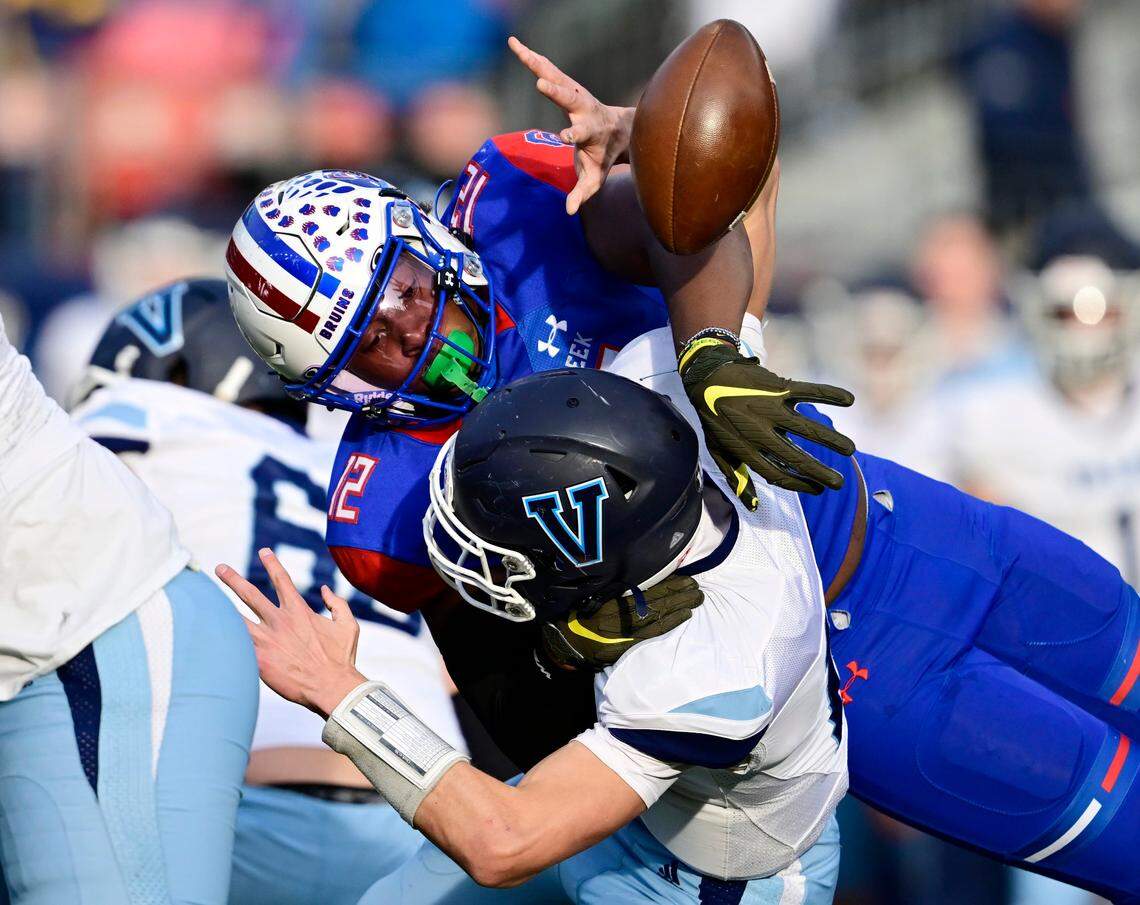 Blake Purchase (12), right, forces a fumble from Valor Christian Eagles QB Asher Weiner (14) in the first quarter of the 2022 Colorado 5A State Championship game at Empower Field at Mile High Stadium in Denver, Colo. on Saturday, Dec. 3, 2022. Creek recovered which led to a field goal.