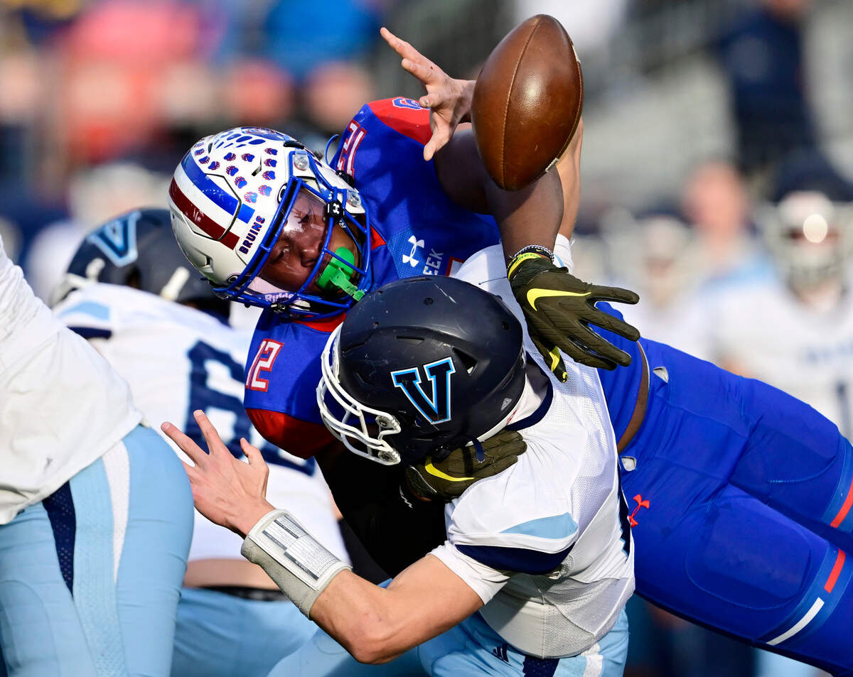 Blake Purchase (12), right, forces a fumble from Valor Christian Eagles QB Asher Weiner (14) in the first quarter of the 2022 Colorado 5A State Championship game at Empower Field at Mile High Stadium in Denver, Colo. on Saturday, Dec. 3, 2022. Creek recovered which led to a field goal.