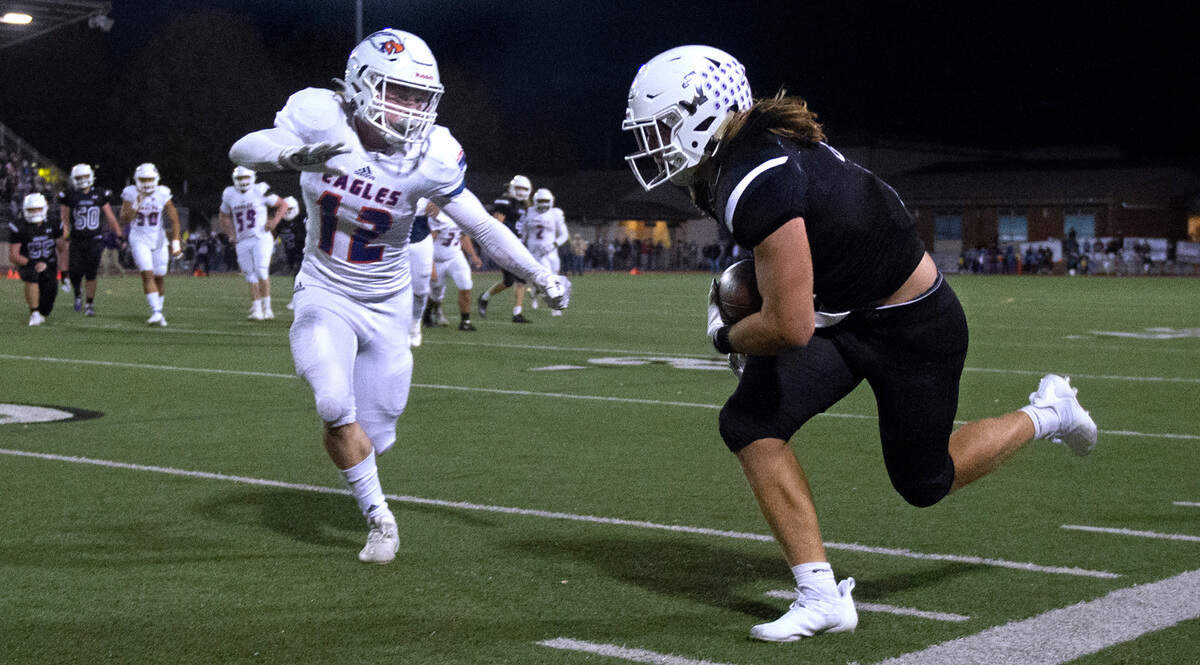 Graham-Kapowsin defensive back Cameron Sonnenfeld closes in on Sumner running back Peyton Wing during Saturday night’s 4A SPSL high school football game at Sunset Chev Stadium in Sumner, Washington, on Oct. 16, 2021.