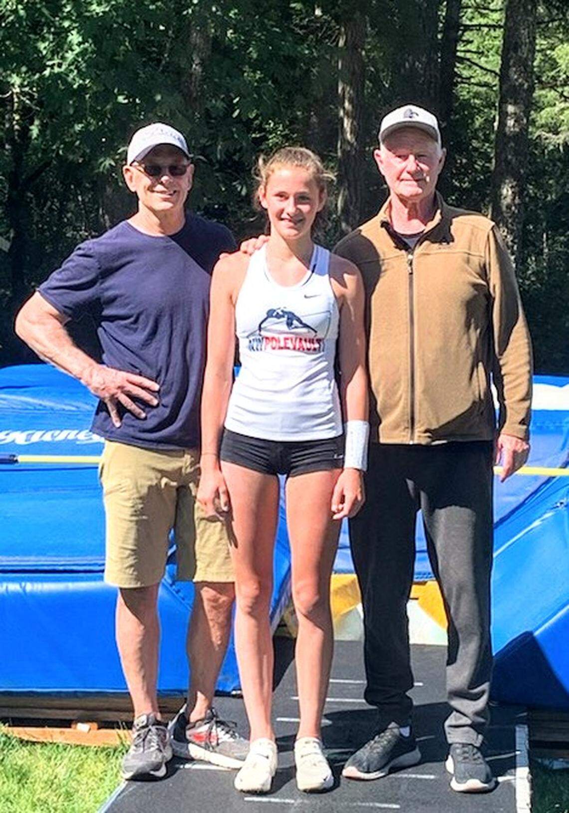 Amanda Moll, center, with coaches Tim Reilly, left, and Mike Strong, after setting her personal record 14 feet, 3.75 inches in the pole vault in July 2020.