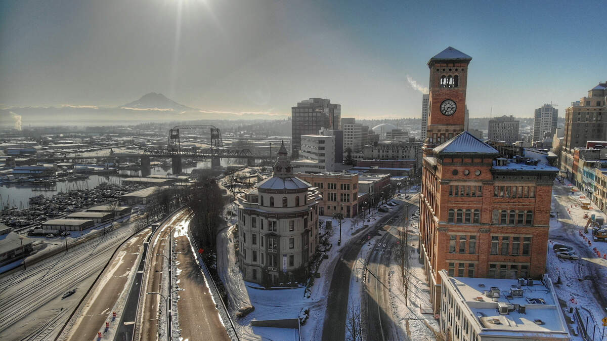 A view of Old City Hall and Mount Rainier during a break in the weekend’s snowstorm.