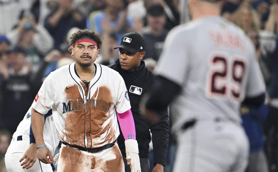 Seattle Mariners first baseman Josh Naylor (12) stares down Detroit Tigers pitcher Tarik Skubal (29) after stealing third base during the second inning of Game 5 of the AL Division Series at T-Mobile Park, on Friday, Oct. 10, 2025, in Seattle.