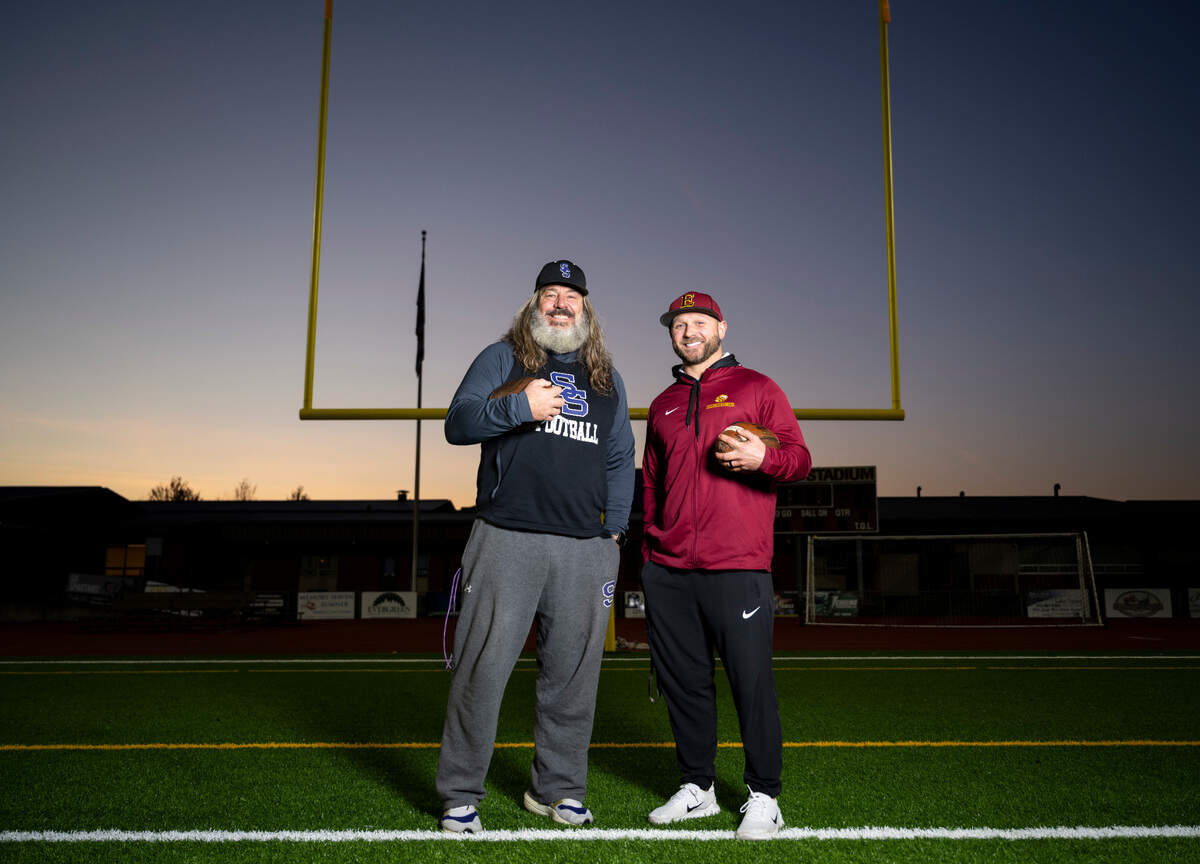 Sumner High School football coach Keith Ross, left, and Enumclaw High School football coach Mark Gunderson, right, pose for a portrait on the field at Sunset Chev Stadium in Sumner, Wash. on Nov. 16, 2022.