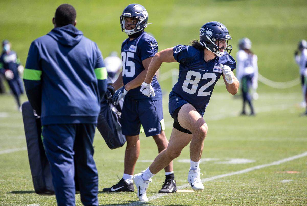 Tight end Luke Willson pushes off a tackling dummy before accelerating into the field during Thursday’s practice. The Seattle Seahawks practiced Thursday, August 13, 2020 at the VMAC in Renton, WA.