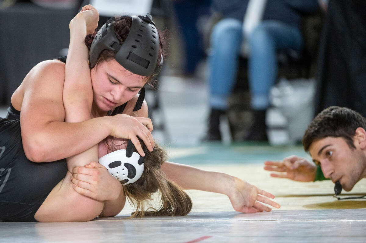Curtis’ Clarissa Wangen pushes down on the face of Bellingham’s Frances Porteous just before the Wangen’s pin during the 155-pound, Girls 3A/4A division championship match at Mat Classic XXXIV on Saturday, Feb. 18, 2023, at the Tacoma Dome in Tacoma, Wash.