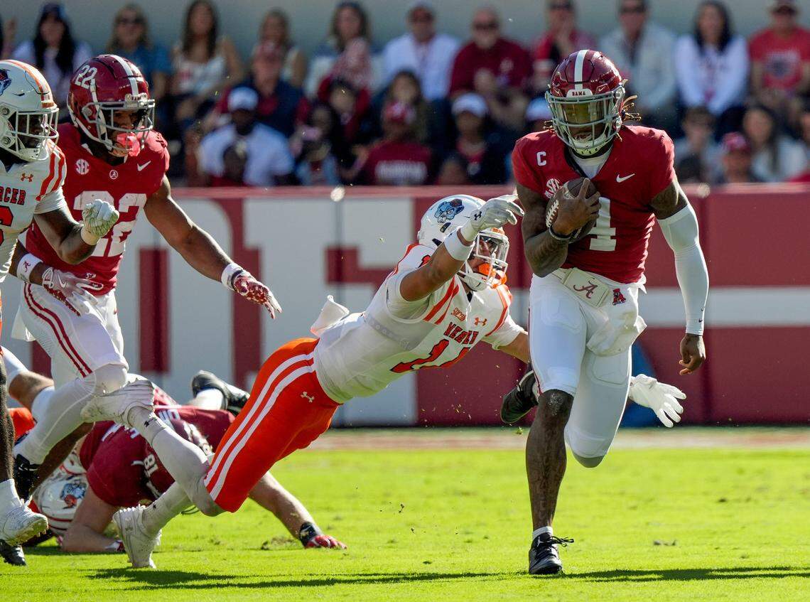 Nov 16, 2024; Tuscaloosa, AL, USA; Mercer safety Chris Joines (14) lunges to try and bring down Alabama Crimson Tide quarterback Jalen Milroe (4) at Bryant-Denny Stadium. Mandatory Credit: Gary Cosby Jr.-Tuscaloosa News