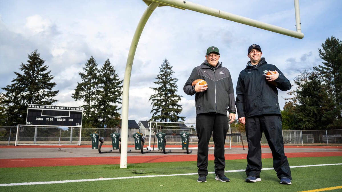 Auburn High School football coach Aaron Chantler, right, and defensive coordinator Gordon Elliott, left, pose for a portrait on the field at Auburn Memorial Stadium in Auburn, Wash. on Nov. 1, 2022.