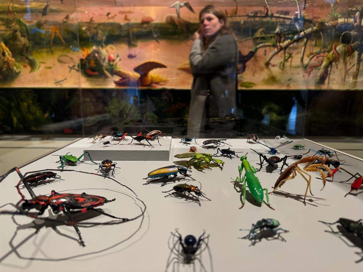 A mural-sized painting by Portland artist Alexis Rockman provides a backdrop for glass insects by Italian artist Vittorio Costantini at “Field Notes: Artists Observe Nature” at Tacoma’s Museum of Glass Saturday, Nov. 16, 2024.