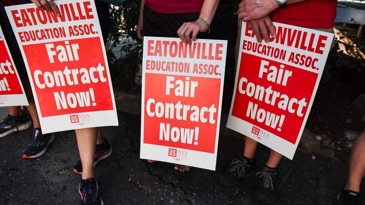Teachers in Eatonville hold signs during a silent vigil outside the Eatonville School District Office on Thursday, Sept. 1, 2022. The Eatonville Education Association has authorized a strike beginning Wednesday, Sept. 7, if a labor dispute is not resolved.