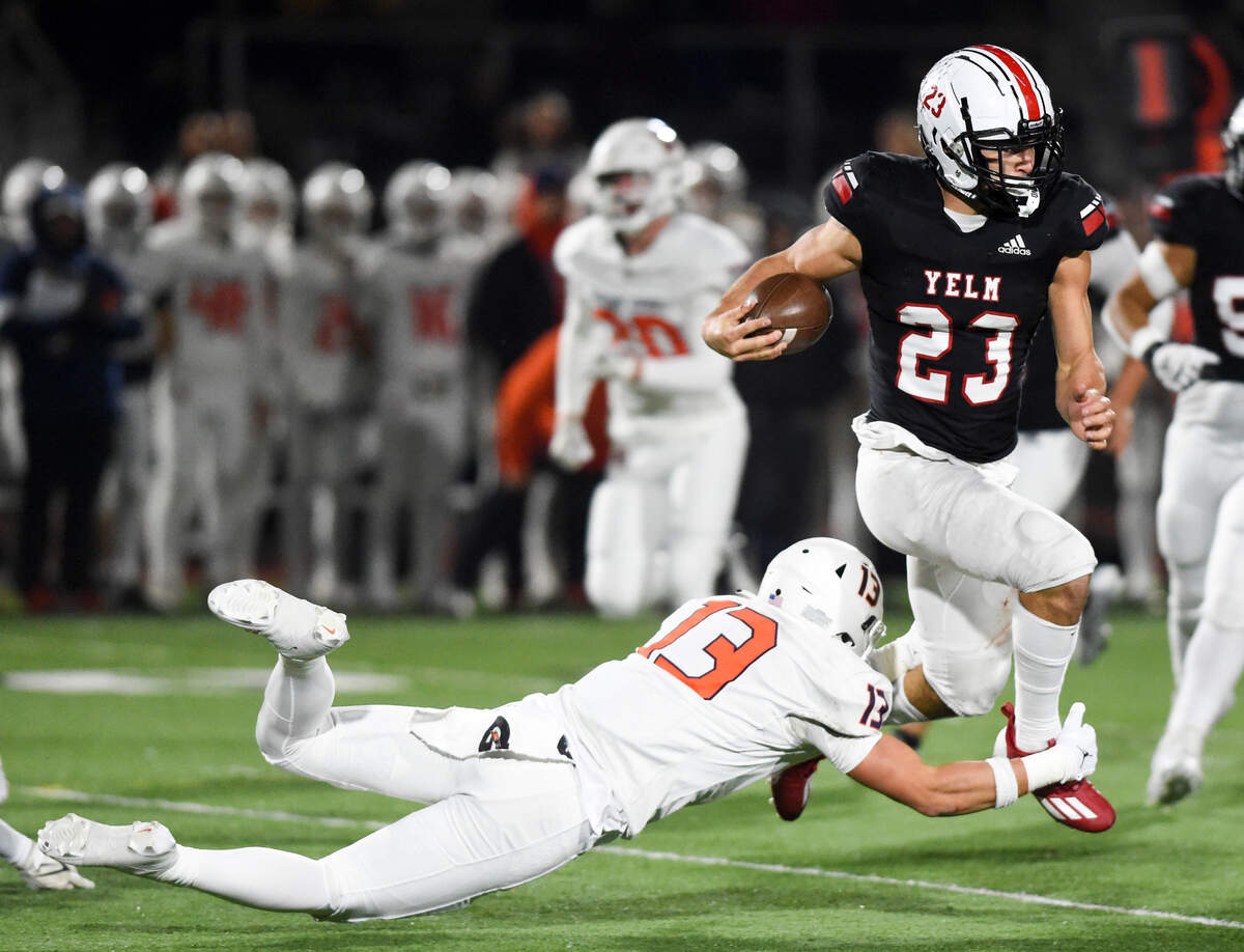 Yelm’s Brayden Platt (23) evades a tackle from Eastside Catholic’s Skyler Shute (13) during the first half of the 3A semifinal state game at Art Crate Field, Saturday, Nov. 25, 2023, in Spanaway, Wash.