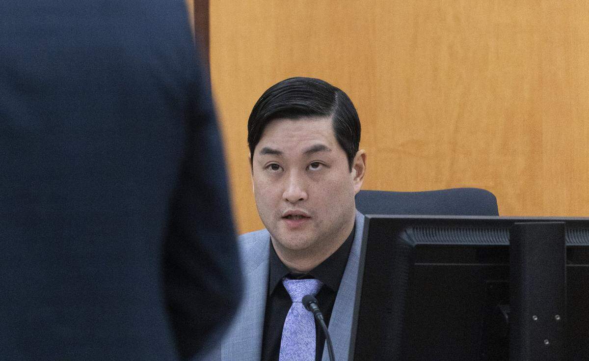 Defendant Timothy Rankine answers questions from defense attorney Mark Conrad, left.