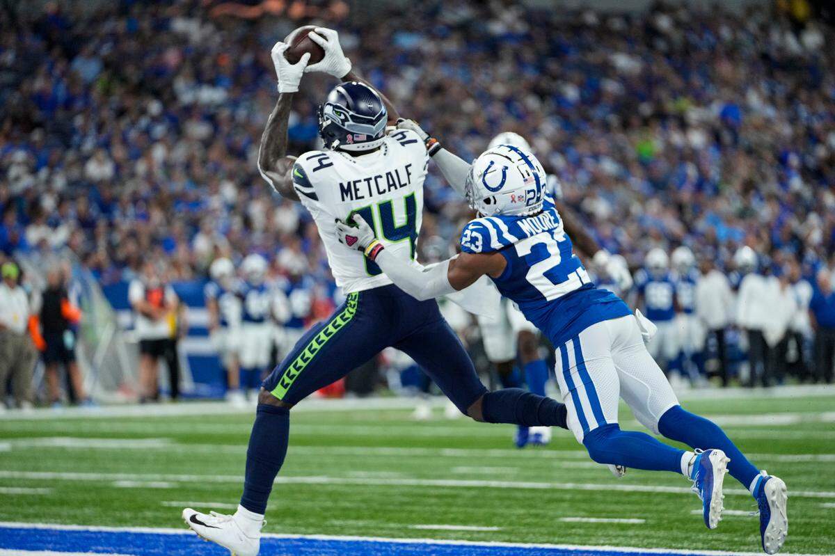 Seattle Seahawks wide receiver DK Metcalf (14) makes a catch in front of Indianapolis Colts cornerback Kenny Moore II (23) for a touchdown during the second half of an NFL football game in Indianapolis, Sunday, Sept. 12, 2021. (AP Photo/AJ Mast)