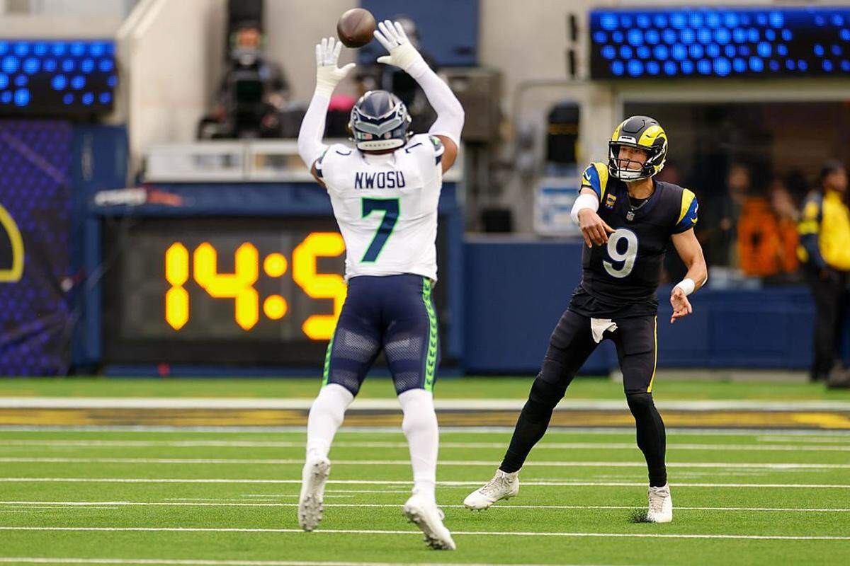 Los Angeles Rams quarterback Matthew Stafford (9) passes the ball defended by Seattle Seahawks linebacker Uchenna Nwosu (7) during the first quarter at SoFi Stadium on November 16, 2025 in Inglewood, California. (Photo by Harry How/Getty Images)