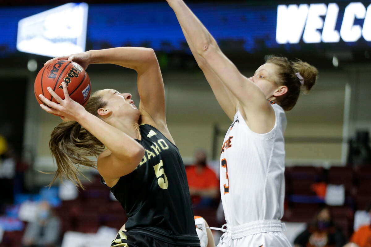 Idaho guard Beyonce Bea (5) looks to shoot past Idaho State forward Ellie Smith during an NCAA college basketball game in the championship of the Big Sky Conference in Boise, Idaho, Friday, March 12, 2021. (AP Photo/Otto Kitsinger)
