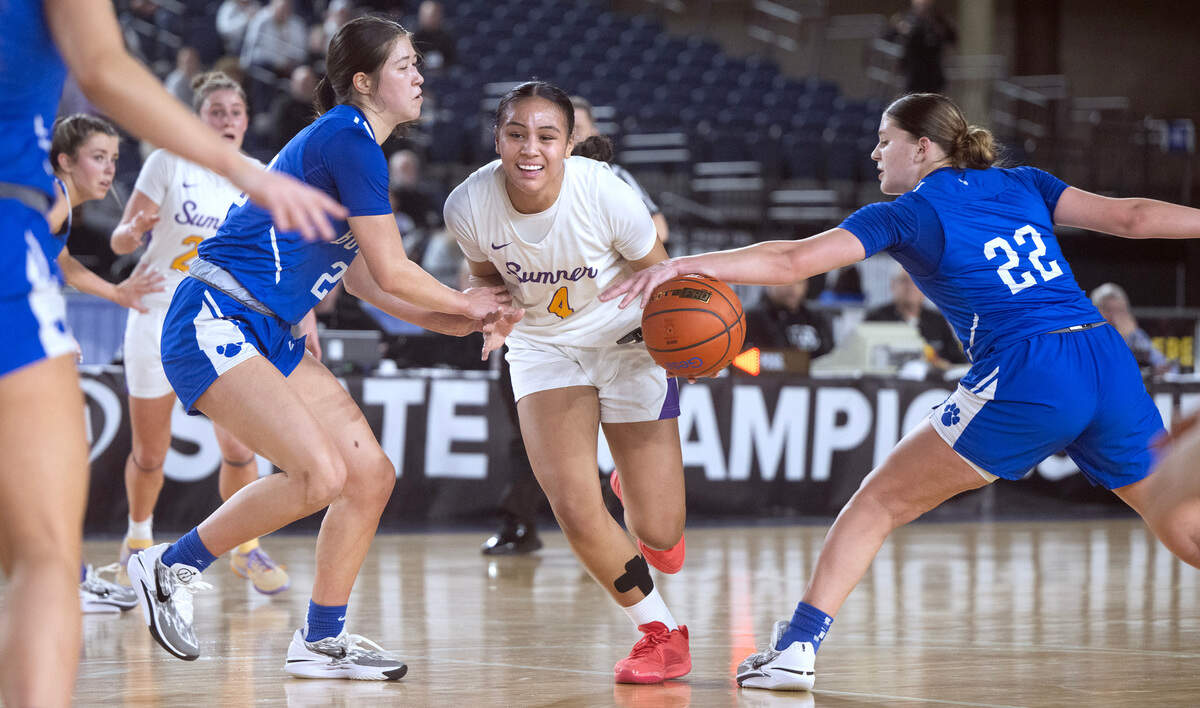 Sumner’s Kawehi Borden has the ball stripped away as she drives the lane between Bothell defenders Yuna McConnell (left) and Charlotte Lipkin during Thursday morning’s quarterfinal game of the 4A girls state basketball tournament in the TacomaDome in Tacoma, Washington, on Thursday, Feb. 29, 2024. After trailing by as many as 15 points at multiple time in the game, Sumner rallied to tie the game in the fourth quarter, then won the game in overtime, 54-52.