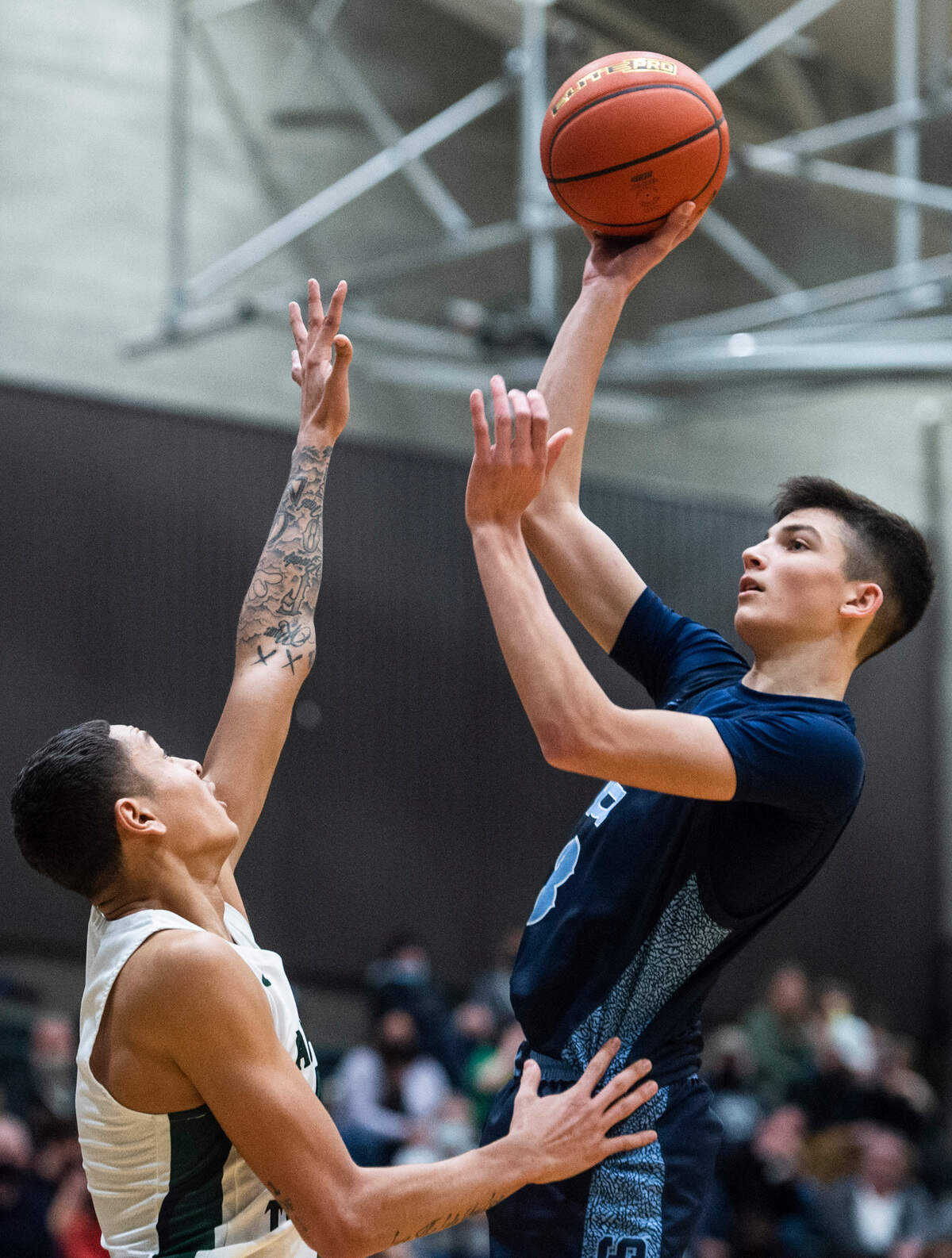 Gig Harbor guard Will Landram (3) jumps to shoot over Auburn guard Trevon Blassingame (2) during a District 3/4 boys basketball tournament opening round game at Auburn High School on Saturday, Feb. 12, 2022, in Auburn, Wash.