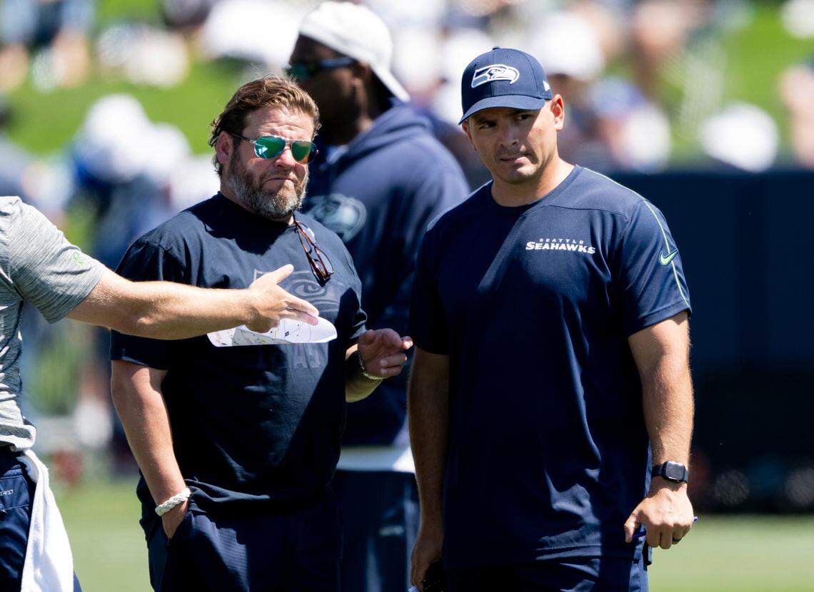 Seahawks general manger John Schneider and head coach Mike Macdonald talk during the first day of Seattle’s NFL training camp at the Virginia Mason Athletic Center, on Wednesday, July 24, 2024, in Renton.