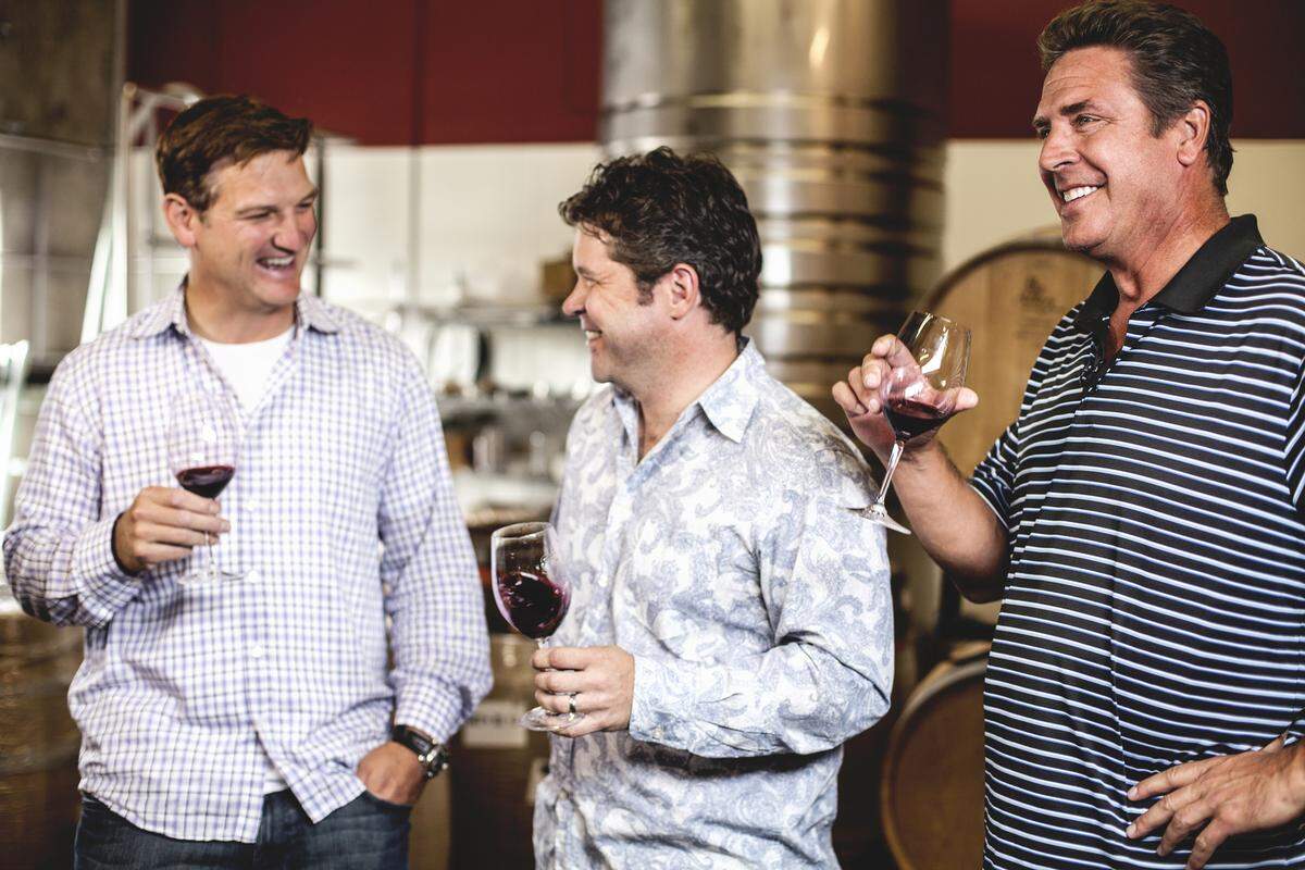 Damon Huard, left, Chris Peterson and Dan Marino are the driving forces behind Passing Time, a Woodinville winery. Huard and Marino are retired NFL quarterbacks, and Peterson is winemaker and co-owner of Avennia Wines in Woodinville.