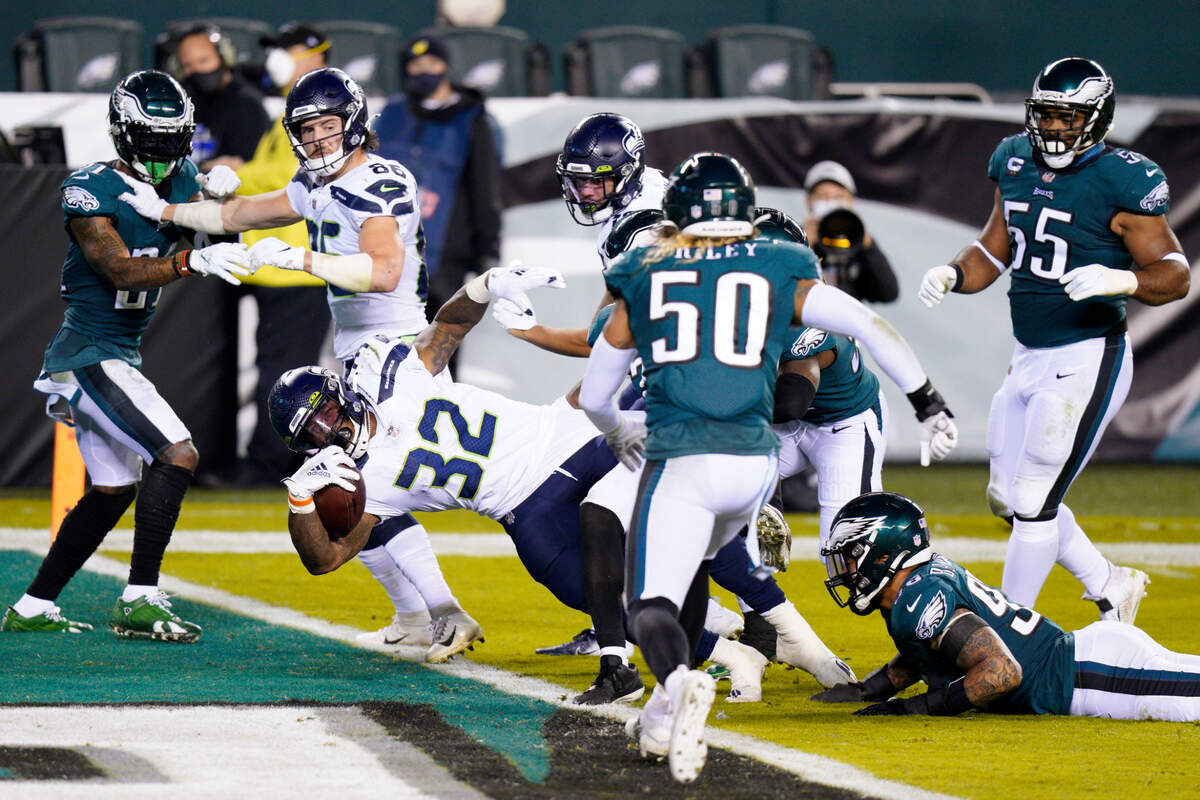Seattle Seahawks’ Chris Carson (32) scores a touchdown during the first half of an NFL football game against the Philadelphia Eagles, Monday, Nov. 30, 2020, in Philadelphia. (AP Photo/Chris Szagola)