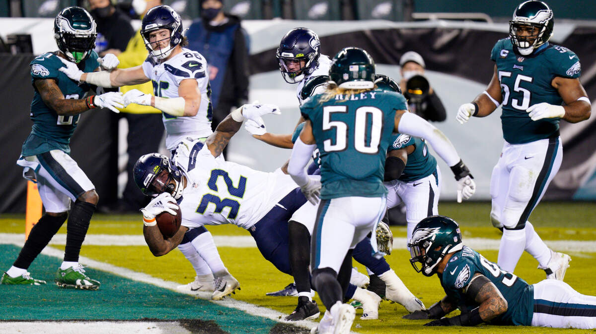 Seattle Seahawks’ Chris Carson (32) scores a touchdown during the first half of an NFL football game against the Philadelphia Eagles, Monday, Nov. 30, 2020, in Philadelphia. (AP Photo/Chris Szagola)