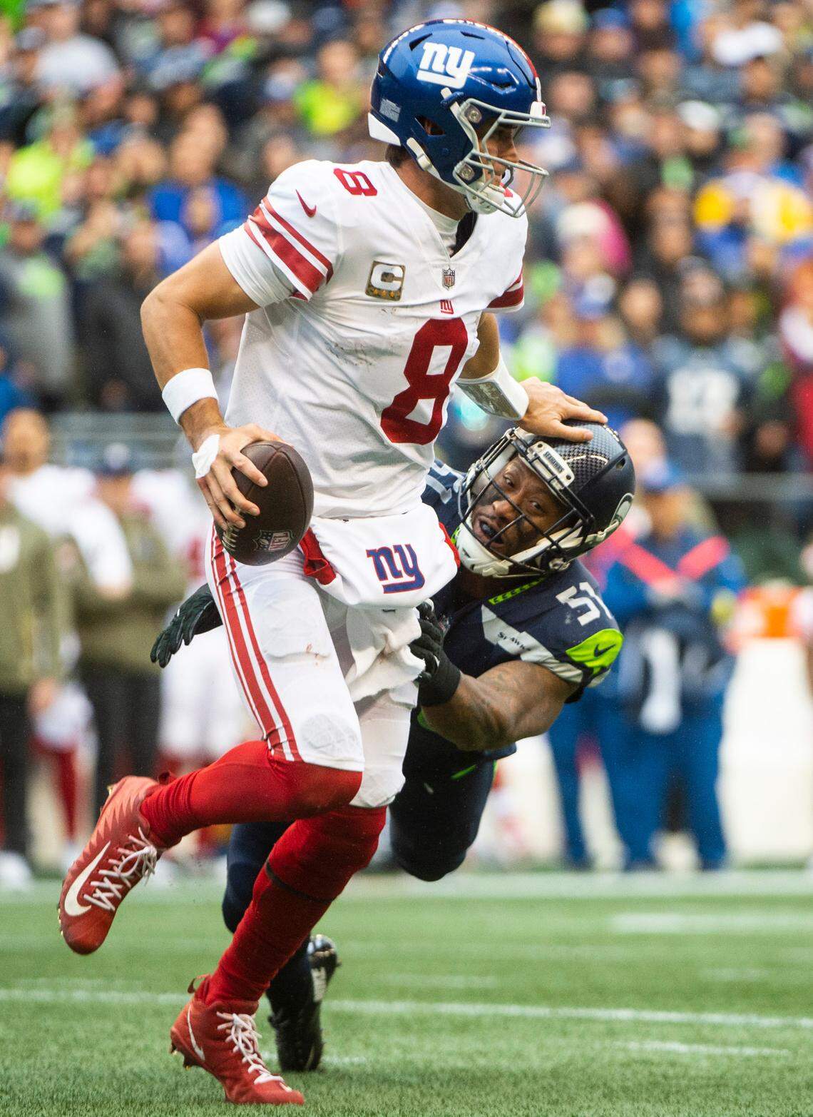 New York Giants quarterback Daniel Jones (8) shoves Seattle Seahawks linebacker Bruce Irvin (51) off of him as he runs with the ball in the fourth quarter of an NFL game at Lumen Field in Seattle, Wash. on Oct. 30, 2022. The Seahawks defeated the Giants 27-13.