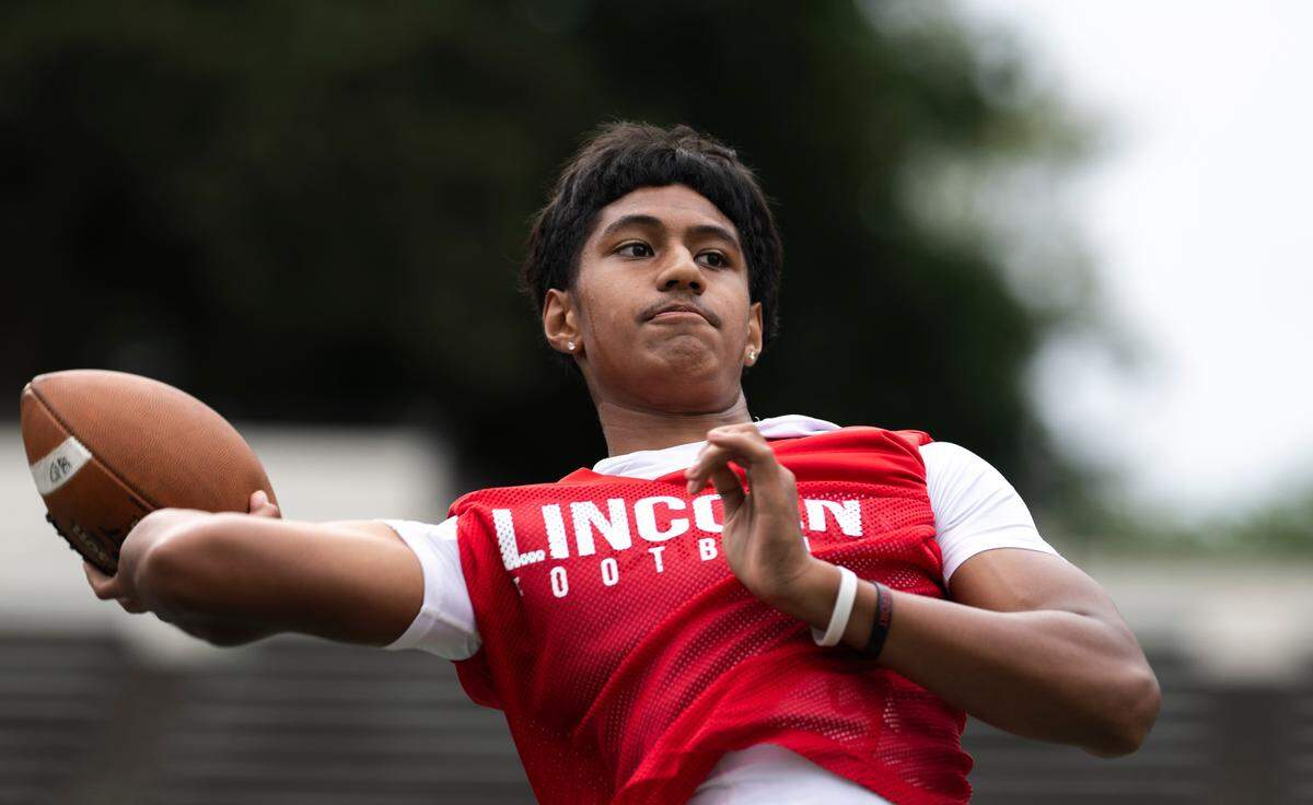 Lincoln quarterback Sione Kaho&nbsp;throws passes during a football practice at Lincoln high School, on Wednesday, Aug. 21, 2024, in Tacoma, Wash.