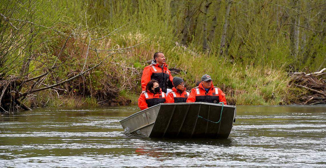 While piloting a boat down the Nisqually River Chairman Willie Frank lll, Chairman of the Nisqually Indian Tribe gives am overview of the river bank condition to, from left, U.S. Sen. Maria Cantwell, U.S. Rep. Marilyn Strickland and Washington Gov. Jay Inslee during an April 11 tour of the I-5 Nisqually bridge. The event was hosted by the Nisqually Indian Tribe with the goals of pointing out challenges the I-5 Nisqually bridge poses to the Nisqually River Delta.