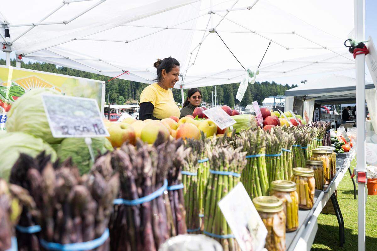 Paty Robles mans the Carares Farm produce stall at the Waterfront Farmers Market, on Thursday, May 22, 2025, in Gig Harbor. 