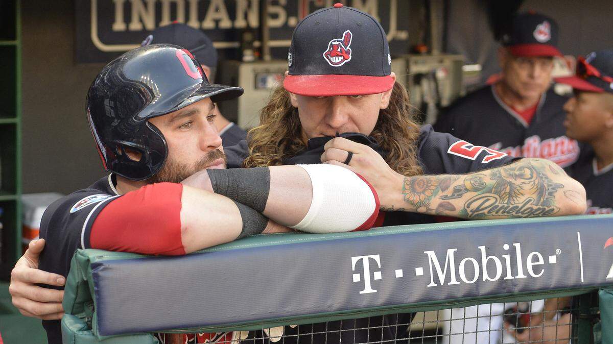 Cleveland Indians’ Jason Kipnis, left, is hugged by starting pitcher Mike Clevinger after the Houston Astros defeated the Indians 11-3 in Game 3 of a baseball American League Division Series, Monday, Oct. 8, 2018, in Cleveland. (AP Photo/Phil Long)
