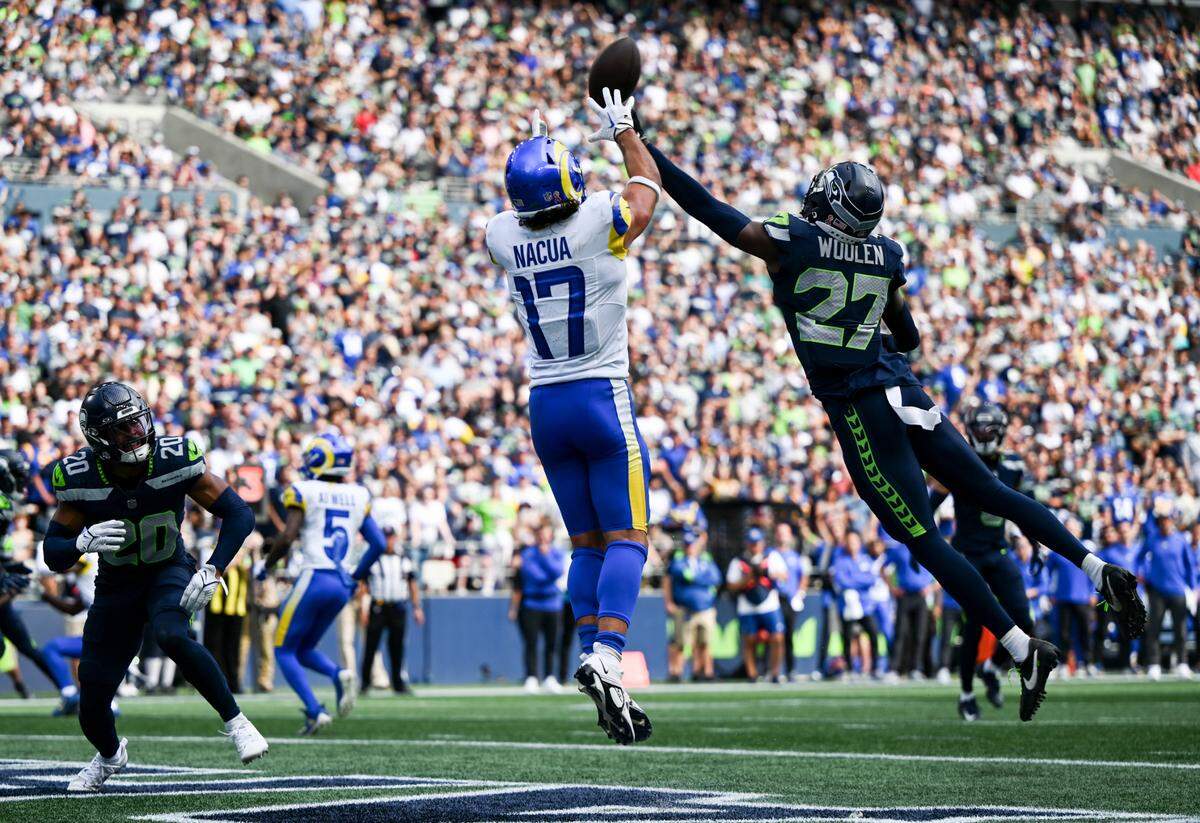 Seattle Seahawks cornerback Riq Woolen (27) tips away a pass intended for Los Angeles Rams wide receiver Puka Nacua (17) during the fourth quarter of the NFL game at Lumen Field, Sunday, Sept. 10, 2023, Seattle, Wash.