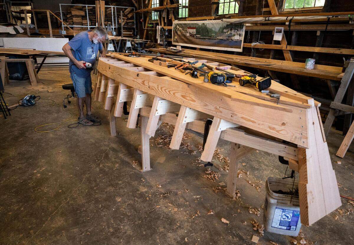 Anthony “Mike” Vlahovich works on a Croatian fishing boat, named ‘The Batana’, that is being built as part of a project known as “The Batana Project” at the Gig Harbor Boat Shop in Gig Harbor, Wash. on Wednesday, July 20, 2022. Once the boat is complete, the boat shop will host a revealing event on September 3rd.