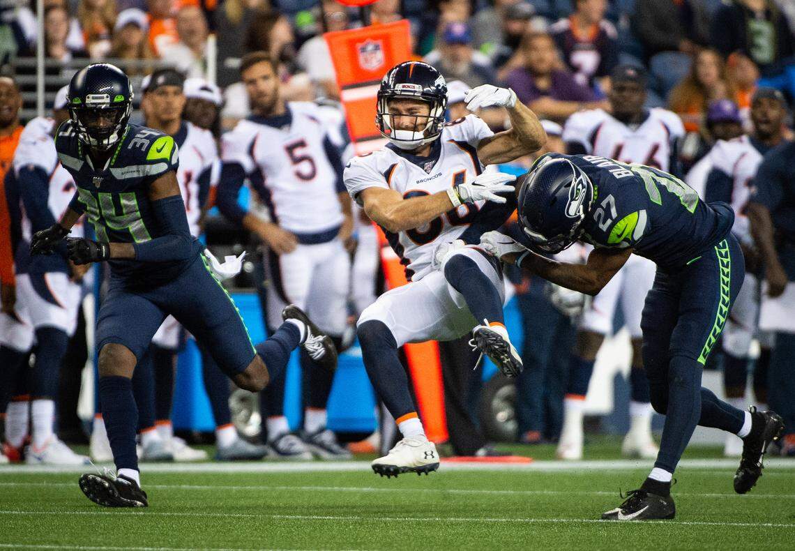 Seattle Seahawks defensive back Marquise Blair (27) lays a big hit on Broncos tight end Nick Williams (86) during the fourth quarter. The Seattle Seahawks played the Denver Broncos in a NFL preseason game at CenturyLink Field in Seattle, Wash., on Thursday, Aug. 8, 2019.