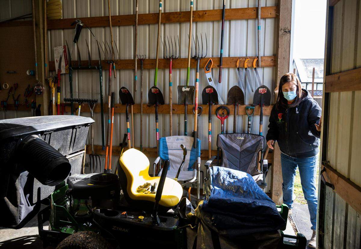 Melissa Meyer, Rose Island Farm owner, opens the barn door where most of the farming tools are stored at the farm on Thursday, Feb. 24, 2022, in Tacoma, Wash. Rose Island Farm is an Indigenous-owned family farm that provides skill share workshops, food and herbal supports for the BIPOC community.