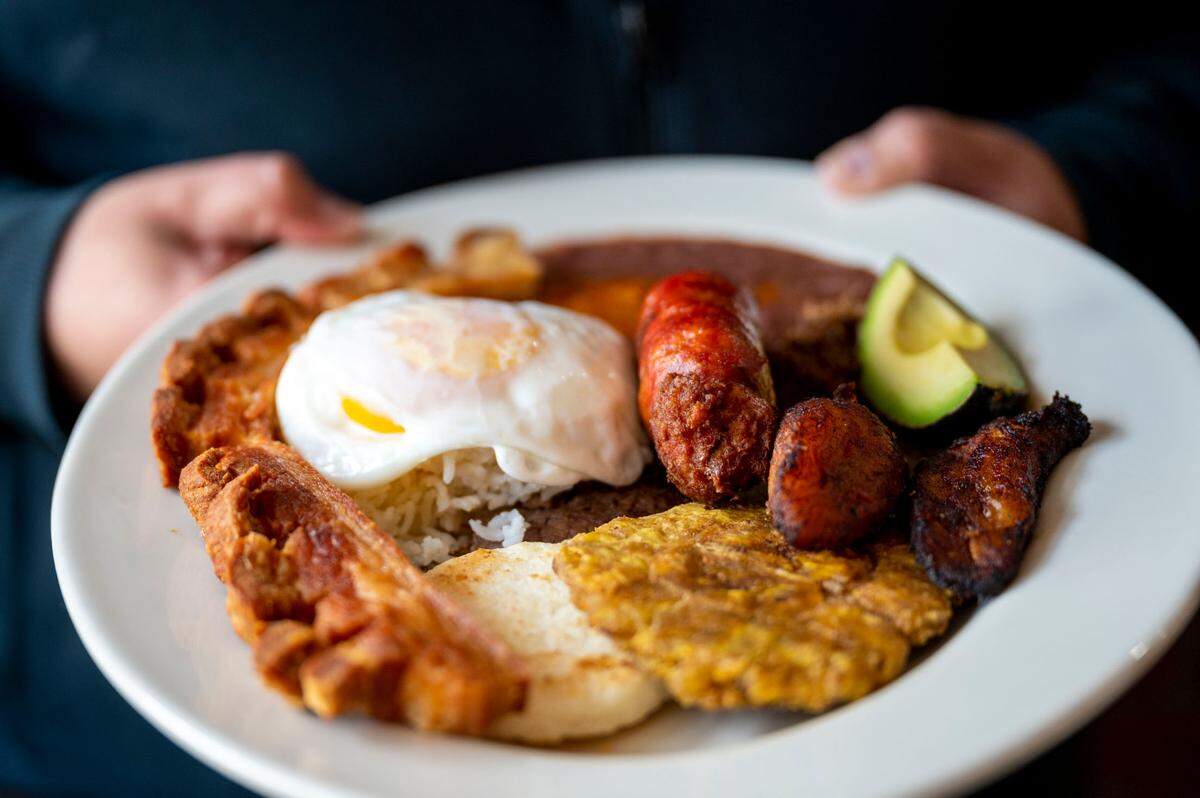 Colombia’s national dish, bandeja paisa, packs chorizo, steak, chicharrone, sweet and green plantains onto one plate with rice, beans and a fried egg. It’s one of the most popular dishes at El Parche Colombiano at 6324 E Mckinley Ave. in Tacoma, Wash.