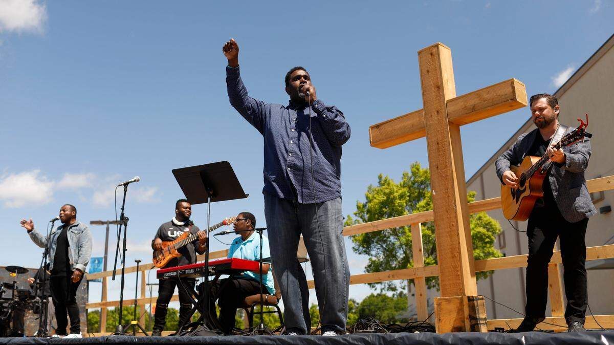 Pastor Lance Brooks leads the worship band during a drive-in outdoor church service at Cornerstone Church in Athens, Georgia, on Sunday, April 26.