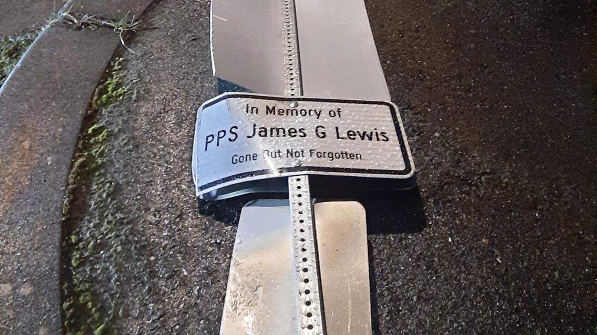 A DUI suspect dragged this sign for fallen Tacoma Police officer James G. Lewis for several blocks before stopping in an attempt to remove it, police said.