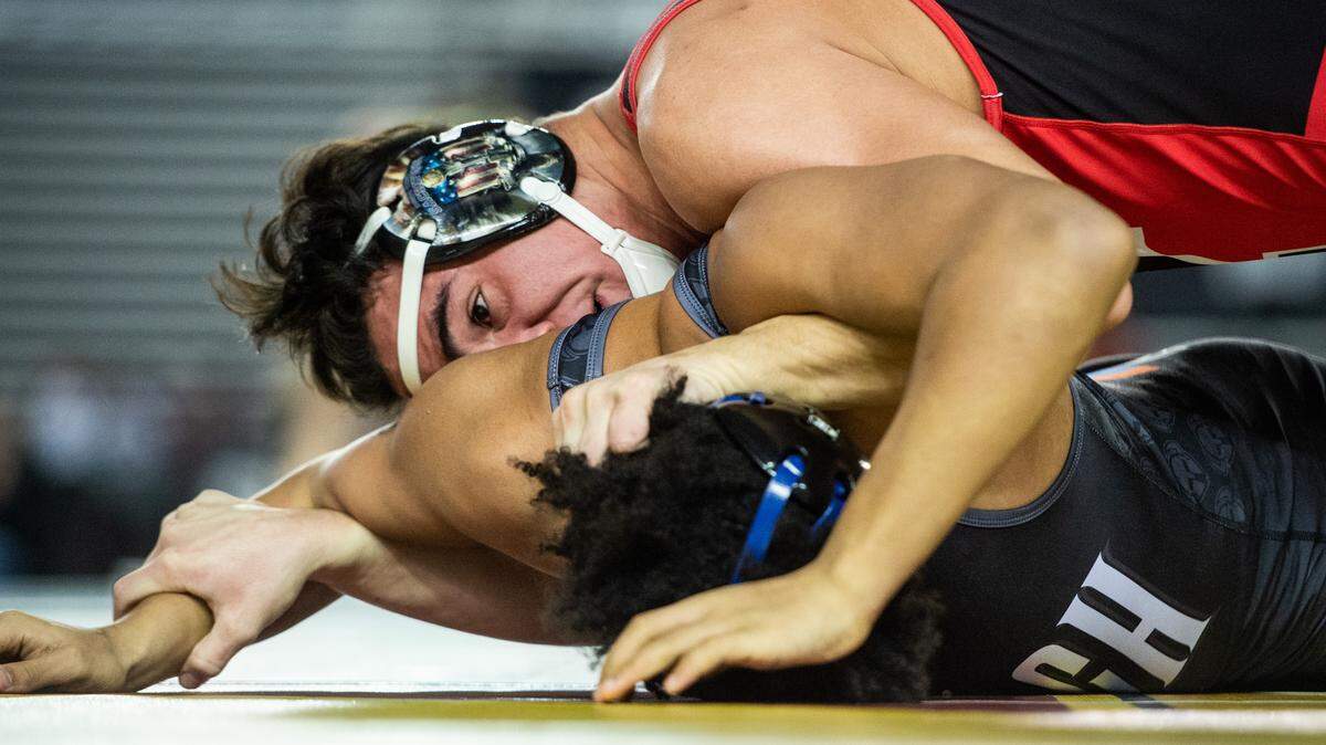 Yelm’s Derrick Platt works to pin Rainier Beach’s Jacob Parmer during a match at Mat Classic XXXI at the Tacoma Dome in Tacoma, Wash., on Friday, Feb. 15, 2019.