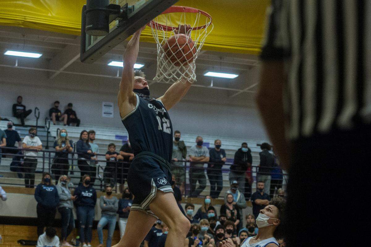 Olympia High School forward Jackson Grant throws down a dunk during the 4A SPSL boys basketball championship game against Curtis on Thursday, June 10, 2021 at Puyallup High School in Puyallup, Wash.