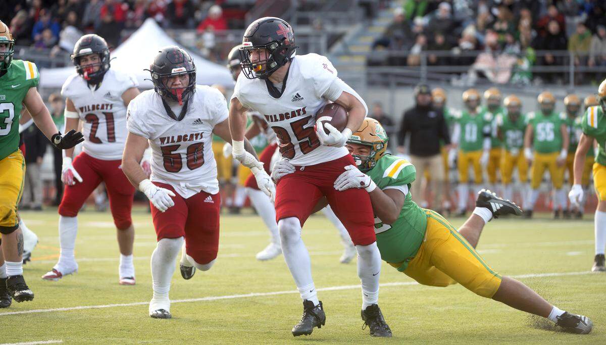 Archbishop Murphy tight end Jack Sievers is tackled for a loss by Tumwater defensive lineman Malijah Tucker during Saturday’s 2A state football semifinal game at Tumwater District Stadium in Tumwater, Washington, on Nov. 30, 2024. Tumwater won the game, 42-0, to advance to next weekend’s state championship game at Husky Stadium in Seattle.