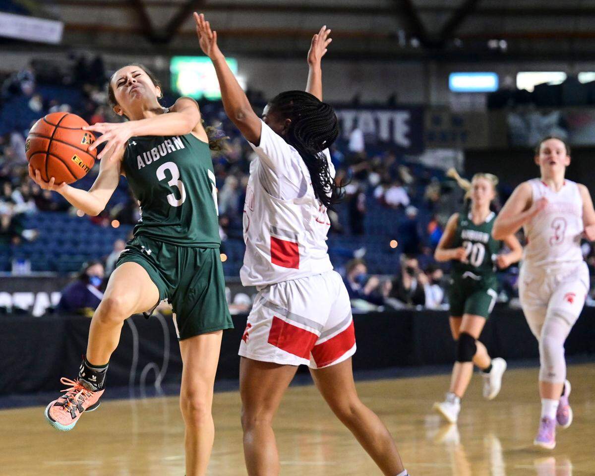 Auburn guard Jaylah Brown (3) attempts a shot after making contact with Stanwood guard Chloe Santeford (20) during the second quarter of a Class 3A state tournament game on Wednesday, March 2, 2022, at the Tacoma Dome, in Tacoma, Wash.