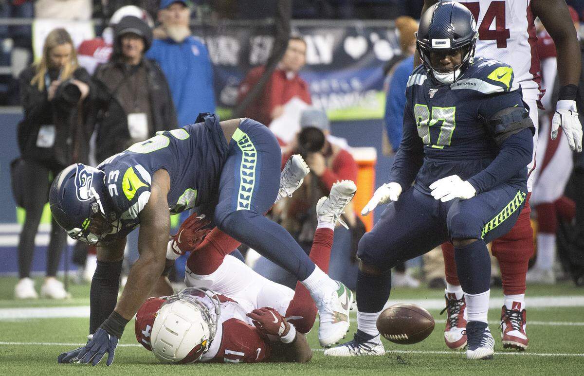 Seattle Seahawks defensive end Branden Jackson (93) knocks the ball loose from Arizona Cardinals wide receiver Larry Fitzgerald (11) during the NFL football game at Centurylink Field on Sunday, Dec. 22, 2019.