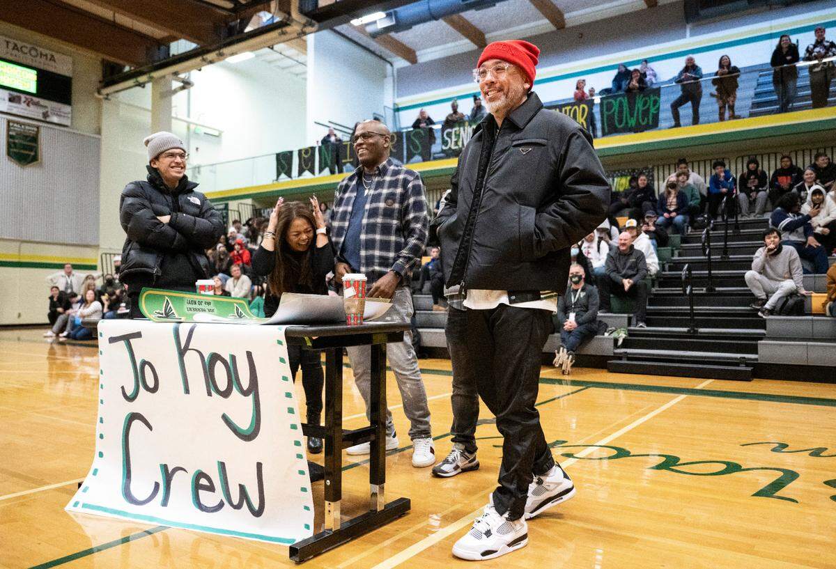 From right, Comedian Jo Koy, his brother-in-law Andre Simmons, his sister Gemma Herbert Simmons and his son Joe Herbert Jr., play a game of Family Feud with Boss High School students at Koy’s alma mater in Tacoma on Nov. 29, 2022.