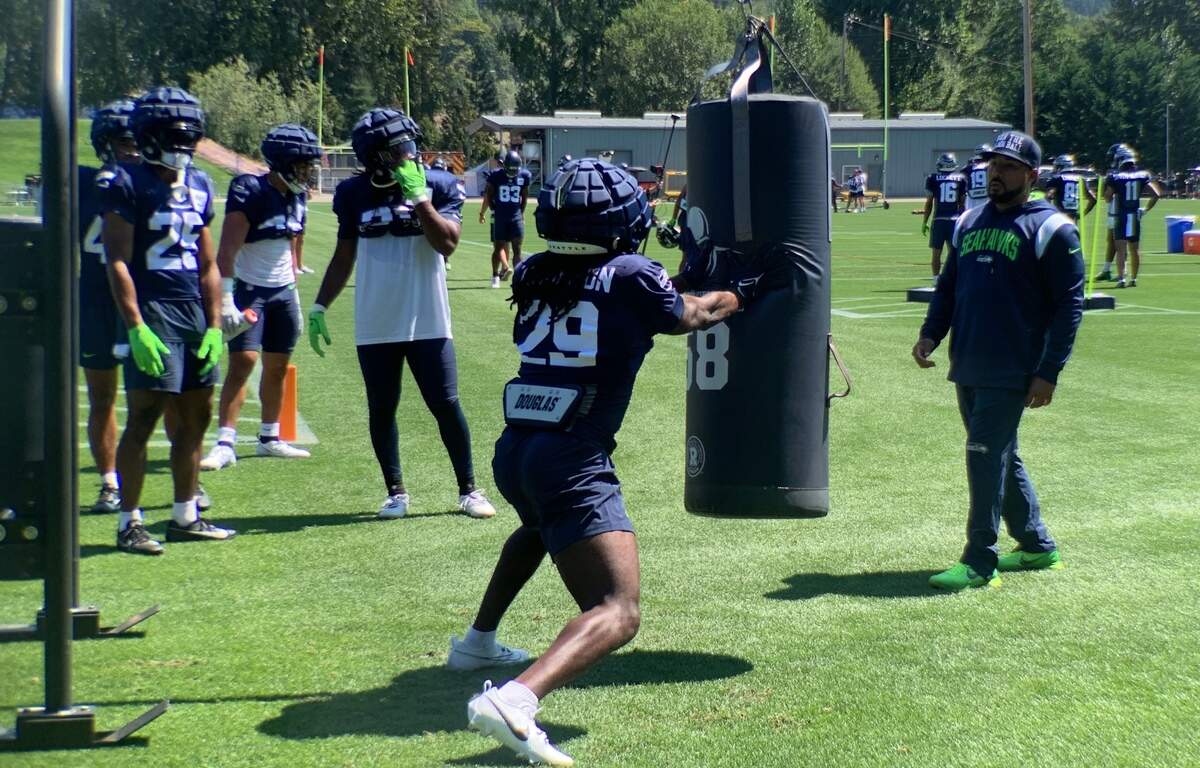 SaRodorick Thompson, an undrafted rookie from Texas Tech signed Monday, in a running-back blocking drill with coach Chad Morton on the fifth day of Seahawks training camp in Renton, July 31, 2023.