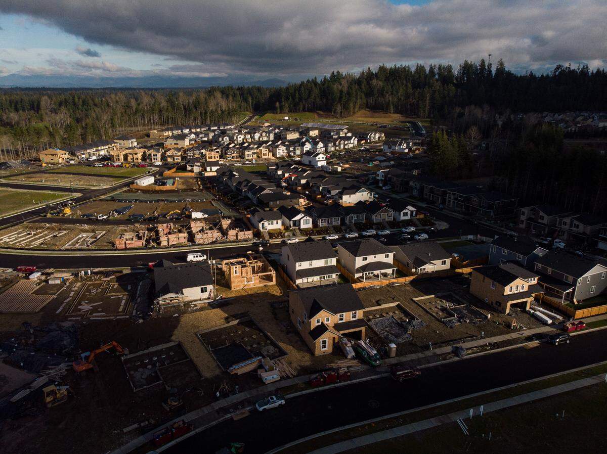 Construction crews work on houses at the Tehaleh development in Bonney Lake, on Monday, Jan. 18, 2021. 
