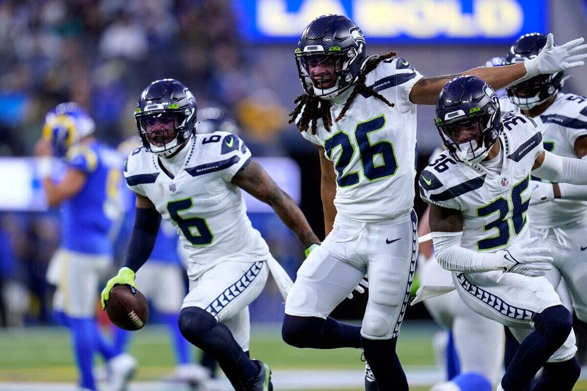 Seattle Seahawks free safety Quandre Diggs (6) and teammates celebrate his pass interception during the first half of the team’s NFL football game against the Los Angeles Rams on Tuesday, Dec. 21, 2021, in Inglewood, Calif. (AP Photo/Ashley Landis)