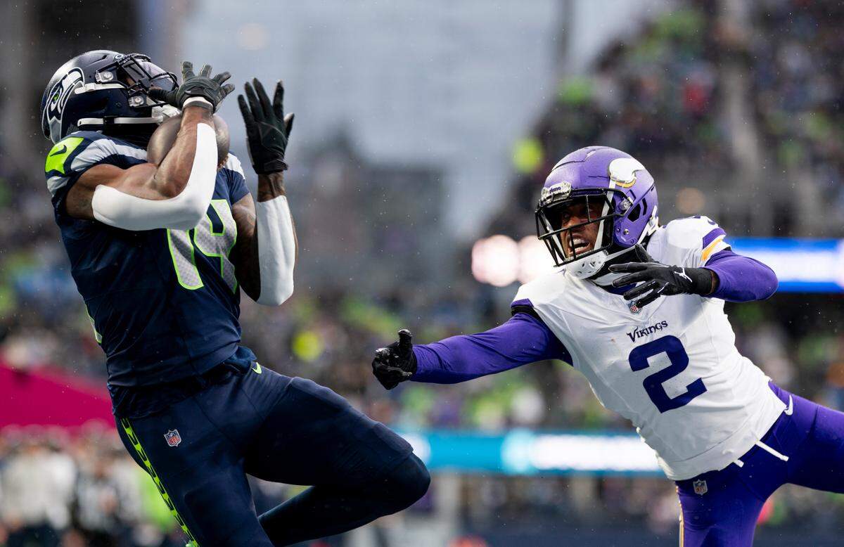 Seattle Seahawks wide receiver DK Metcalf (14) catches a touchdown pass against Minnesota Vikings cornerback Stephon Gilmore (2) during the second quarter of the game at Lumen Field, on Sunday, Dec. 22, 2024, in Seattle, Wash.
