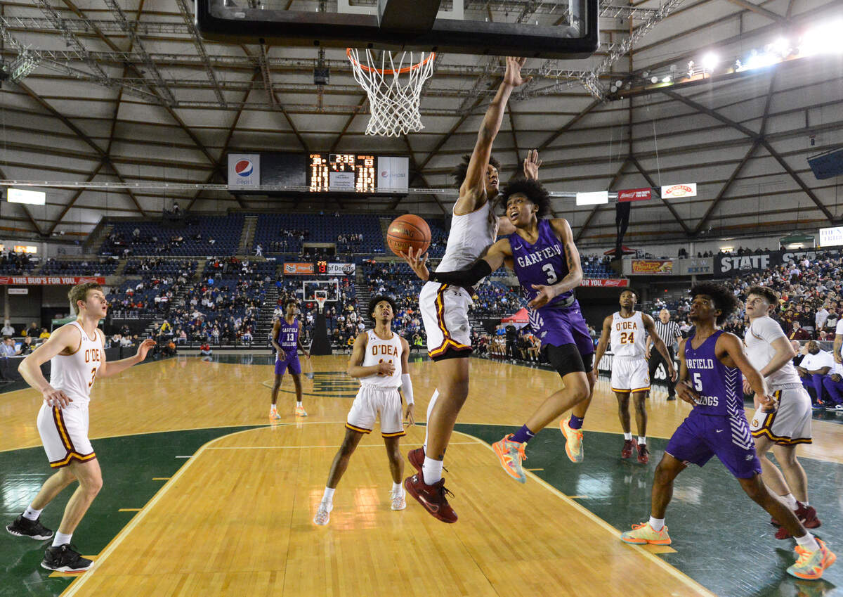 Garfield’s Koren Johnson is fouled by O’Dea’s Paolo Banchero during the fourth quarter. Garfield played O’Dea in the 3A boys championship game at the Hardwood Classic state basketball tournament at the Tacoma Dome in Tacoma, Wash., on Saturday, March 7, 2020.