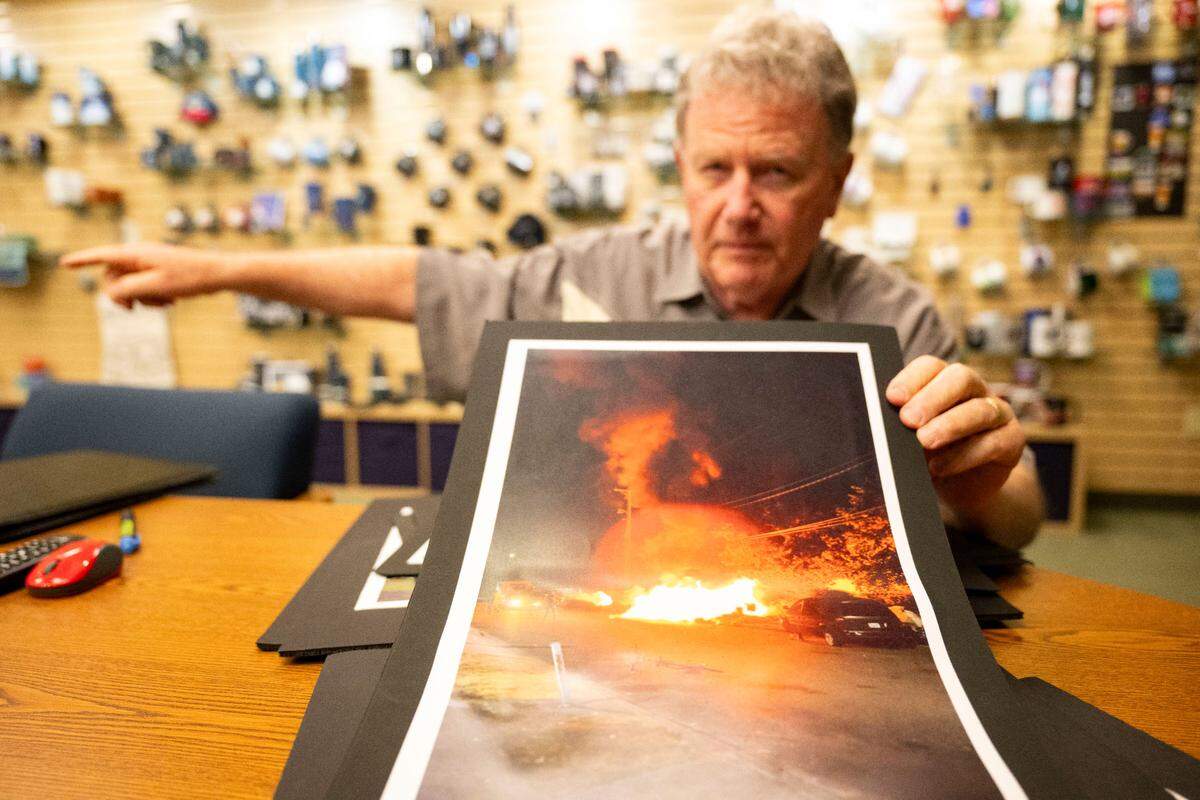 Skip Smith, the owner and president of Smith Western Company, shows a printed photo of a man with a make-shift flame-thrower lighting a car on fire outside his company’s office last winter. Smith Western is located 2223 S 80th St., in south Tacoma, which coincidentally was where large encampments of trailers, car snd RVs congregated late last year. The encampment was cleared away in March, but by early June this year people started to repopulate the area around South Trafton Street and South 80th Street near Smith’s business. Smith, who’s family has operated the company out of Tacoma since 1947, said is main concern is the safety of his employees.