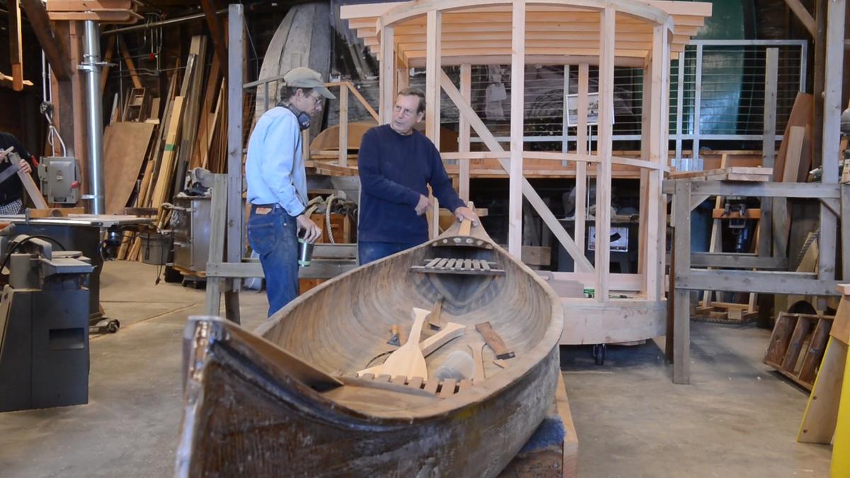 Tom Regan, left, and Larry McAlee work on restoring a Willits Brothers canoe at the Gig Harbor BoatShop.